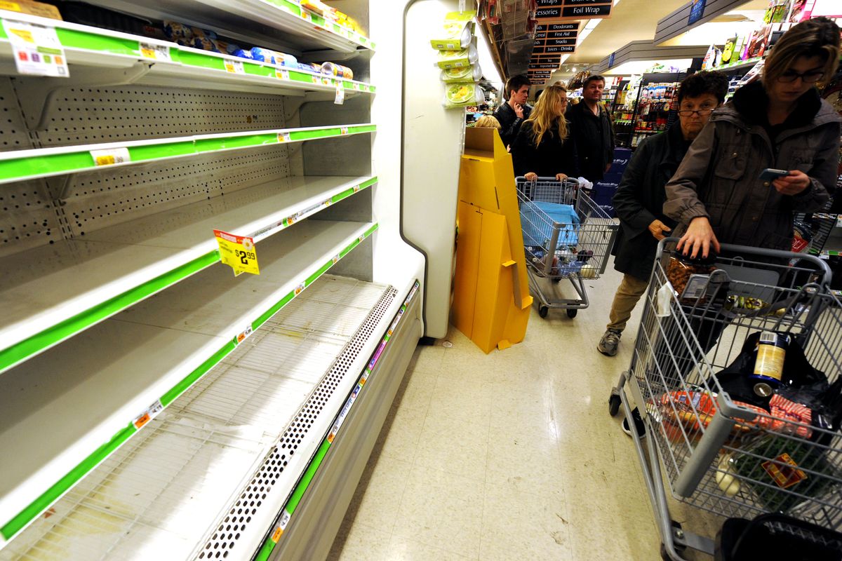 Customers shop for food at a Supermarket in Manhattan, Sunday, Oct. 28, 2012, in New York. Tens of thousands of people were ordered to evacuate coastal areas Sunday as big cities and small towns across the U.S. Northeast braced for the onslaught of a superstorm threatening some 60 million people along the most heavily populated corridor in the nation. (Louis Lanzano / Fr77522 Ap)