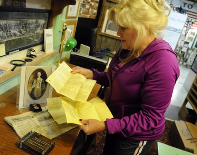 Jayne Singleton looks over the contents of a  box (in foreground on table)  found in the cornerstone of the Odd Fellows Building  demolished this summer. The time capsule, which was filled in 1926 by W.P. Myers (in photograph on table), contained a copy of the  Spokane Valley Herald, as well as Odd Fellows letterhead stationary bearing the names of all the members of good standing.bartr@spokesman.com (J. BART RAYNIAK / The Spokesman-Review)