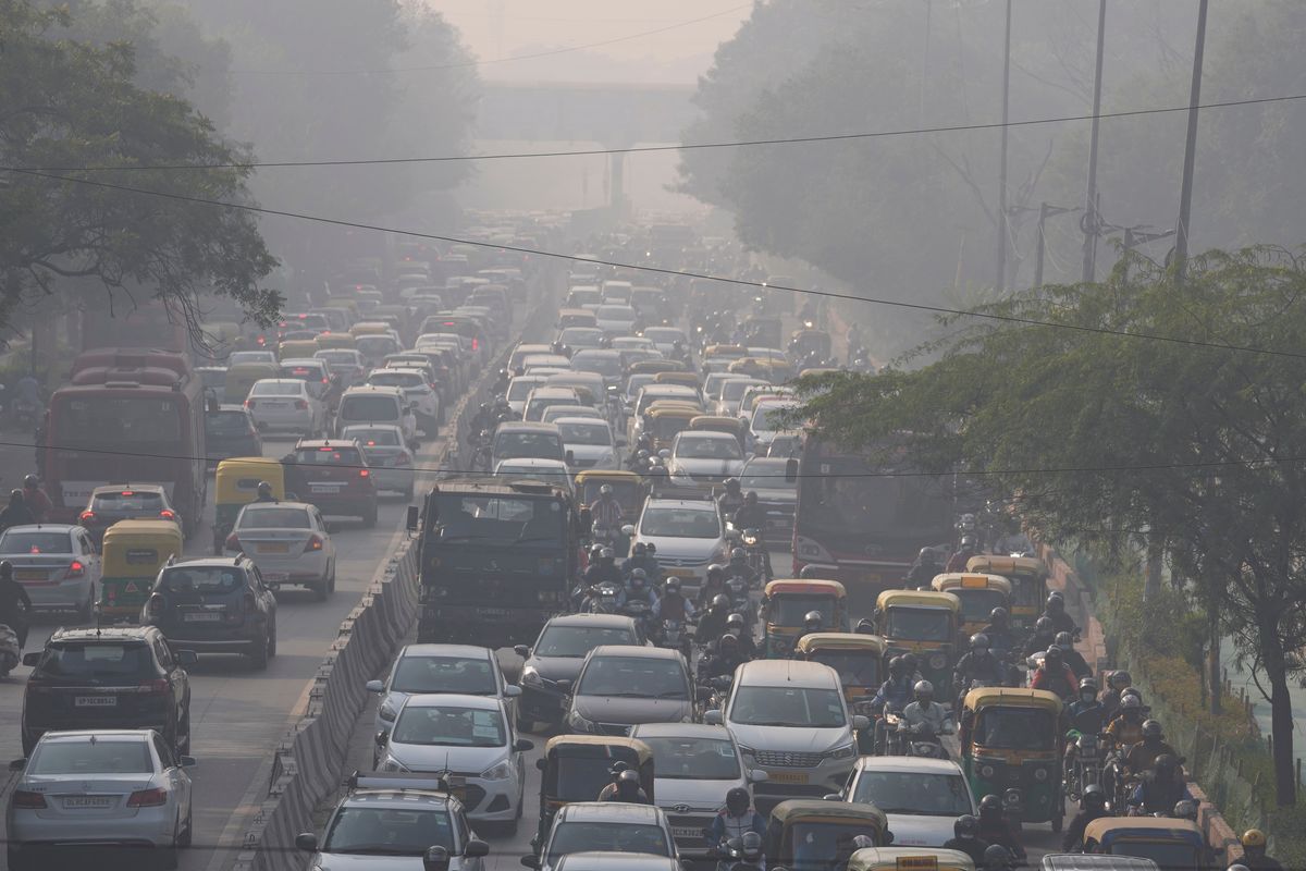 Commuters drive amidst morning haze and toxic smog in New Delhi, India, Wednesday, Nov. 17, 2021. Schools were closed indefinitely and some coal-based power plants shut down as the Indian capital and neighboring states invoked harsh measures Wednesday to combat air pollution after an order from the federal environment ministry panel.  (Manish Swarup)