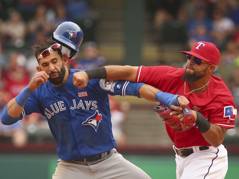 Toronto Blue Jays Jose Bautista (19) gets hit by Texas Rangers second baseman Rougned Odor (12) after Bautista slid into second in the eighth inning of a baseball game at Globe Life Park in Arlington, Texas. (Richard W. Rodriguez / Associated Press)