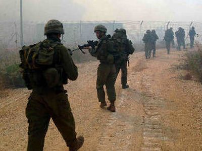 
Israeli soldiers advance toward southern Lebanon, where fierce firefights with Hezbollah militants erupted on Wednesday. 
 (Associated Press / The Spokesman-Review)