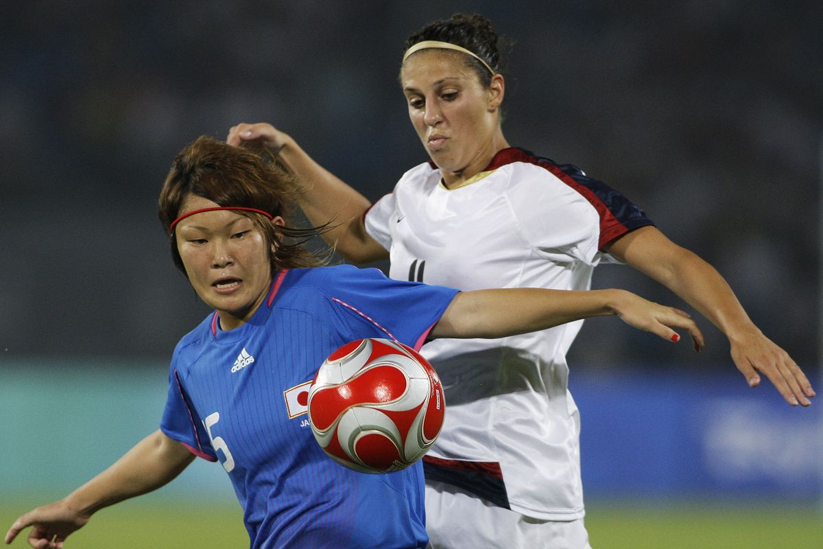In this Aug. 18, 2008, file photo, Carli Loyd, right, of the U.S., vies for the ball with Mizuho Sakaguchi, of Japan, during the Beijing 2008 Olympics women semifinals soccer match in Beijing. Older Olympians will be proving that age is just a number in Tokyo. Lloyd is going to be 39 when she plays for the U.S. women