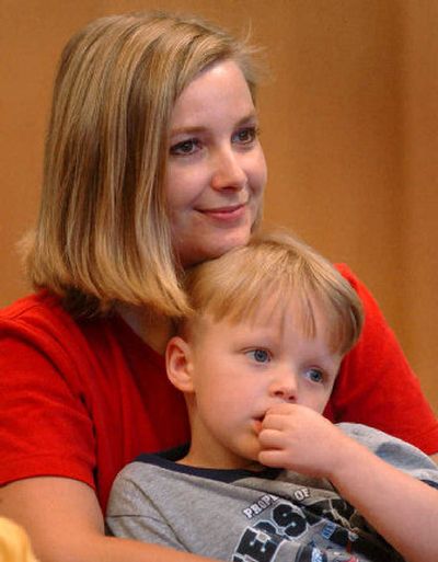 
Deanna Mace holds her son, Ryan, 4, while they listen to Lois Penick as she reads a story  at the Indian Trail Library. 
 (Amanda Smith / The Spokesman-Review)