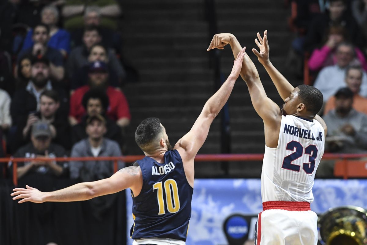 Gonzaga guard Zach Norvell Jr. hits a 3-point shot over UNC Greensboro guard Francis Alonso, Thursday, March 15, 2018 at Taco Bell Arena in Boise. (Dan Pelle / The Spokesman-Review)