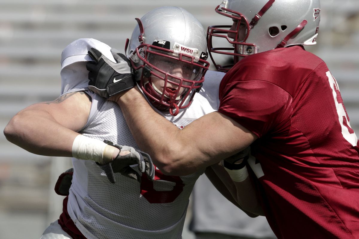 Cory Mackay, left, practices tackling drills on the final day of spring practice last April 25.  (TYLER TJOMSLAND / The Spokesman-Review)
