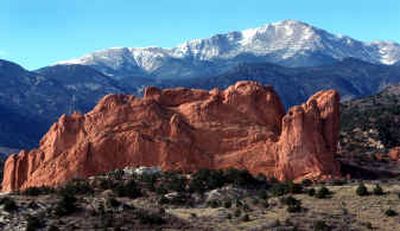 
Pikes Peak stands tall over the bright red rocks of the Garden of the Gods in Colorado Springs. It is named for explorer Zebulon Pike, who visited the area in 1806 and proclaimed the mountain unclimbable.
 (Associated Press / The Spokesman-Review)