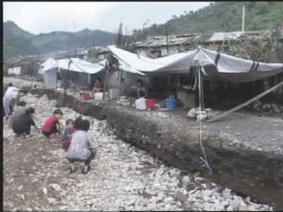 
Flood victims wait outside Pyongyang, the capital of North Korea, on Wednesday. Officials there said floods have destroyed more than one-tenth of the country's farmland.Associated Press
 (Associated Press / The Spokesman-Review)
