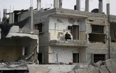A Palestinian man looks out over the rubble of destroyed buildings in Rafah in the south of the Gaza Strip on Monday.  (Associated Press / The Spokesman-Review)