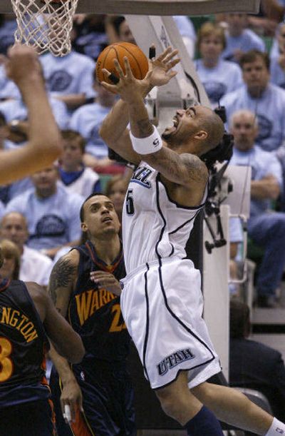 
Utah's Carlos Boozer shoots over Golden State's Matt Barnes during second-quarter action. 
 (Associated Press / The Spokesman-Review)