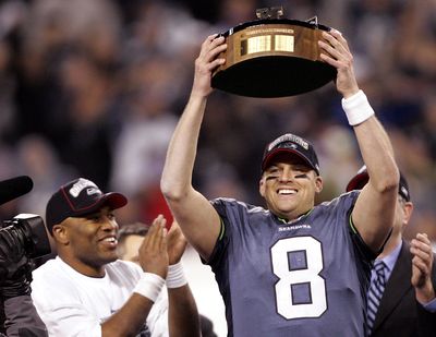 Seattle Seahawks quarterback Matt Hasselbeck, right, holds the NFC championship trophy as he stands with running back Shaun Alexander following their NFC championship football game in Seattle, Sunday, Jan. 22, 2006. The Seahawks best the Carolina Panthers 34-14 to advance to the Super Bowl in Detroit. (Associated Press)