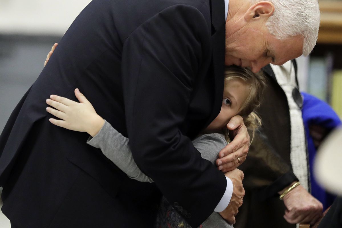 Vice President Mike Pence hugs Evelyn Holcombe at Florseville High School during a stop, Wednesday, Nov. 8, 2017, in Floresville, Texas. (Eric Gay / Associated Press)