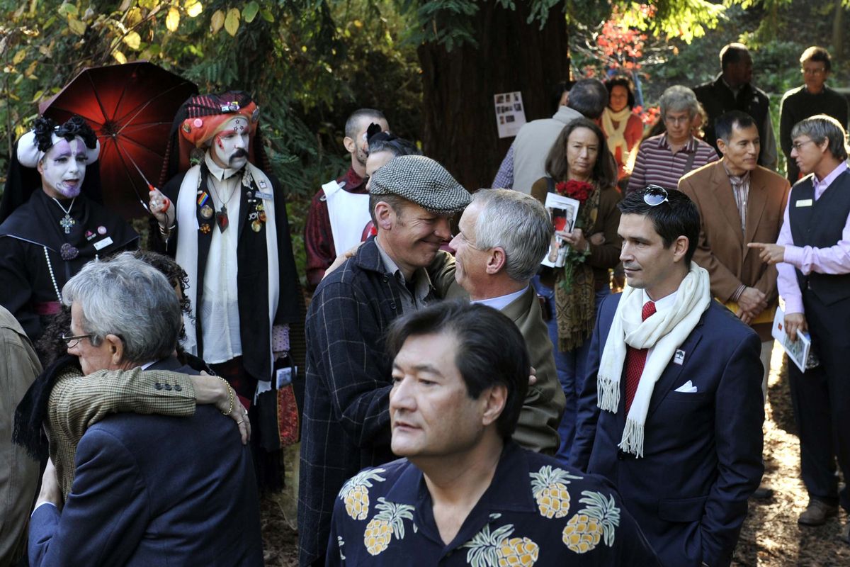 People gather to observe World AIDS Day at the Circle of Friends in the National AIDS Memorial Grove at Golden Gate Park in San Francisco on Tuesday.  (Associated Press)