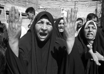 
Women react at the scene of a car bombing in Kufa, Iraq, on Tuesday that killed at least 16 people. 
 (Associated Press / The Spokesman-Review)