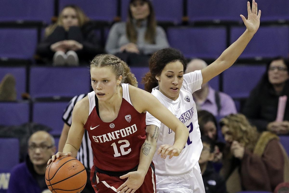 Stanford’s Brittany McPhee moves past Washington’s Mackenzie Wieburg during a Pac-12 game in Seattle on Feb. 23. (Elaine Thompson / AP)