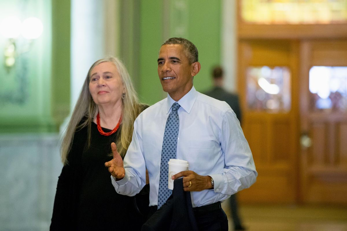 President Barack Obama, accompanied by Pulitzer Prize-winning writer Marilynne Robinson, arrives in 2015 at the State Library of Iowa in Des Moines. (Andrew Harnik / Associated Press)