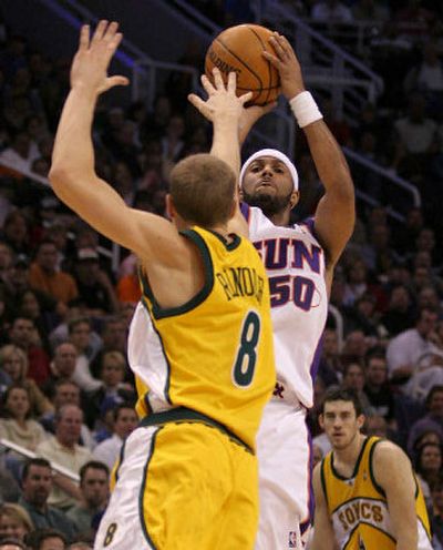 Phoenix's Eddie House shoots a 3-pointer over the SuperSonics' Luke Ridnour during Tuesday's second quarter.
(Associated Press / The Spokesman-Review)