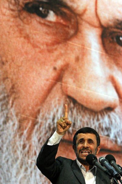 
Mahmoud Ahmadinejad  speaks Sunday on the 18th anniversary of the death of  Ayatollah Khomeini, under his portrait at his mausoleum near Tehran.
 (Associated Press / The Spokesman-Review)