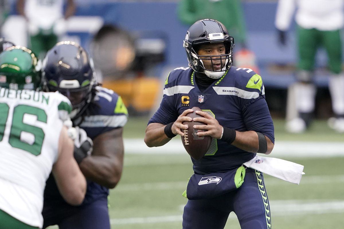 Seattle Seahawks quarterback Russell Wilson looks downfield against the New York Jets during Sunday’s home game in which he threw four touchdown passes.  (Associated Press)