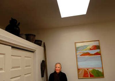 
Spokane artist Meredith Dement poses with a painting titled 