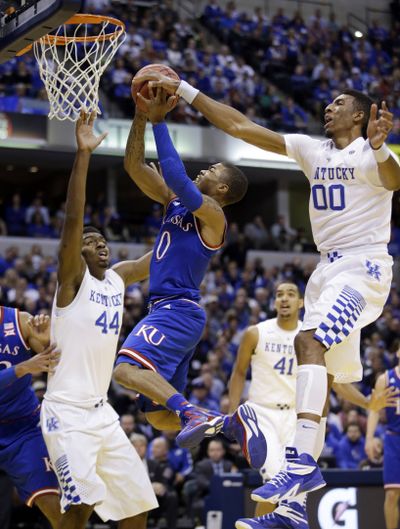 Kentucky’s Marcus Lee rejects a shot by Frank Mason III of Kansas. (Associated Press)