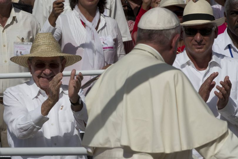 Cuba's President Raul Castro, left, and First Vice President Miguel Diaz-Canel, applaud as Pope Francis arrives at the Plaza of the Revolution to celebrate a Mass, in Holguin, Cuba, earlier today. Francis traveled to the city's plaza for a morning Mass in front of thousands of people with hats and parasols shielding themselves from the sun. (AP Photo/Alessandra Tarantino)