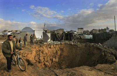 Associated Press file photos Palestinians examine a destroyed tunnel at the border between Gaza and Egypt, in Rafah refugee camp, southern Gaza Strip, on Dec. 31. (Associated Press file photos / The Spokesman-Review)