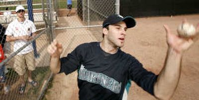 
Seattle Mariners pitcher Brandon Morrow catches a ball thrown to him by a fan as he signs autographs at the team's spring training complex. Associated Press
 (Associated Press / The Spokesman-Review)