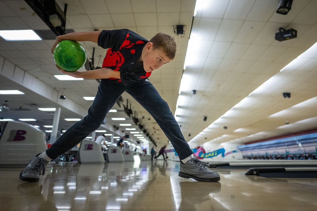 Gleason Garske, 10, uses the two-handed method to bowl during a practice session Tuesday at Lilac Lanes and Casino. Gleason has bowled a 300 game.  (COLIN MULVANY/The Spokesman-Review)