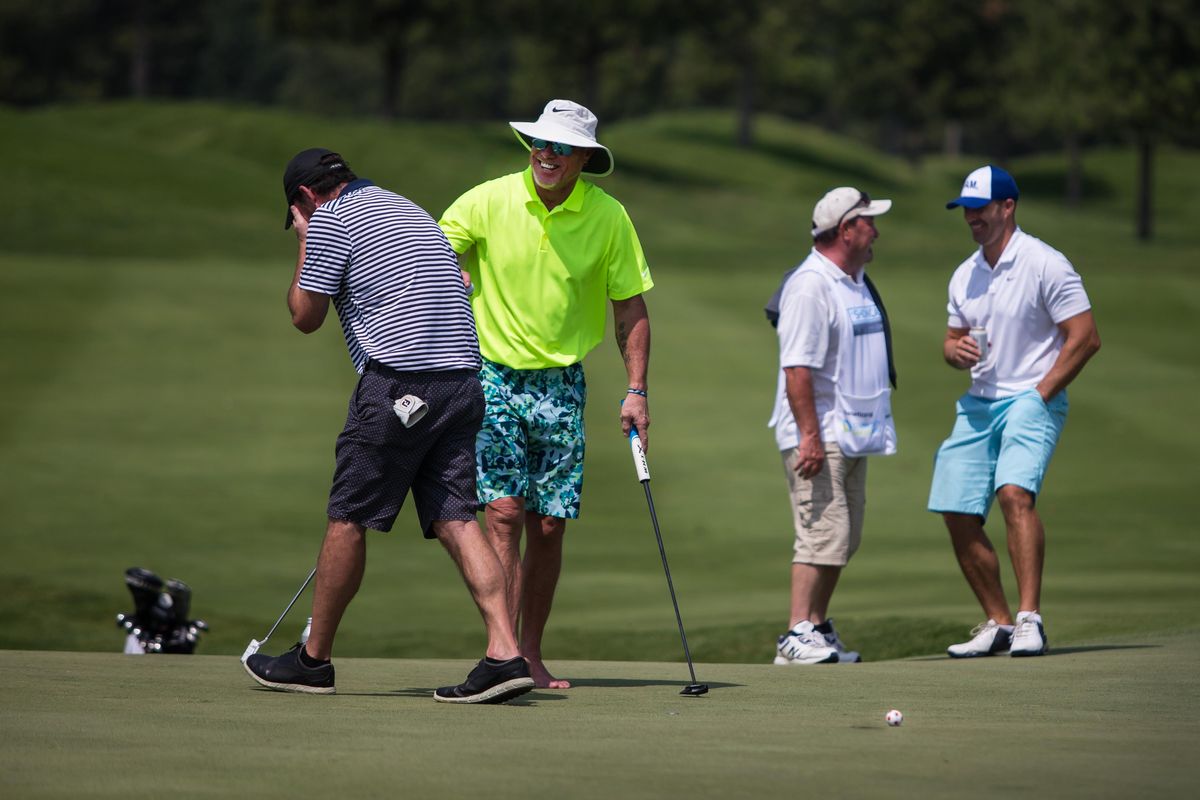 Actor Kevin Dillon, left, hides his face and former NFL quarterback Jim McMahon laughs after Dillon missed a short put on the final hole of the round Saturday, July 28, 2018, while playing in The Showcase at The Coeur d