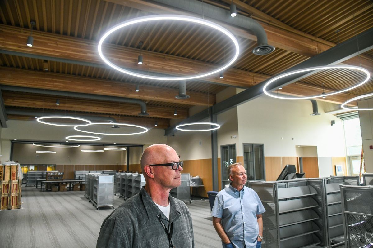 Spokane Public Schools Chief Operations Officer Shawn Jordan, left, and senior advisor Mark Anderson tour the new shared-space 14,000 square foot Shaw Middle School/Spokane Public Library area in the school on Friday.  (DAN PELLE/THE SPOKESMAN-REVIEW)