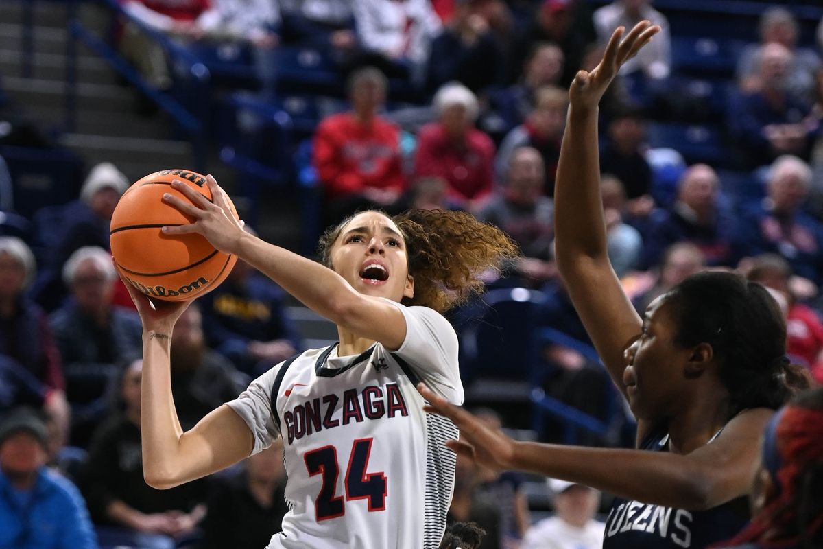 Gonzaga guard McKayla Williams (24) heads to the basket as Queens University of Charlotte center Hawa Balde-Camara (15) defends during the first half of a college basketball game, Tuesday, Dec. 6, 2022 in the McCarthey Athletic Center.  (COLIN MULVANY/THE SPOKESMAN-REVIEW)