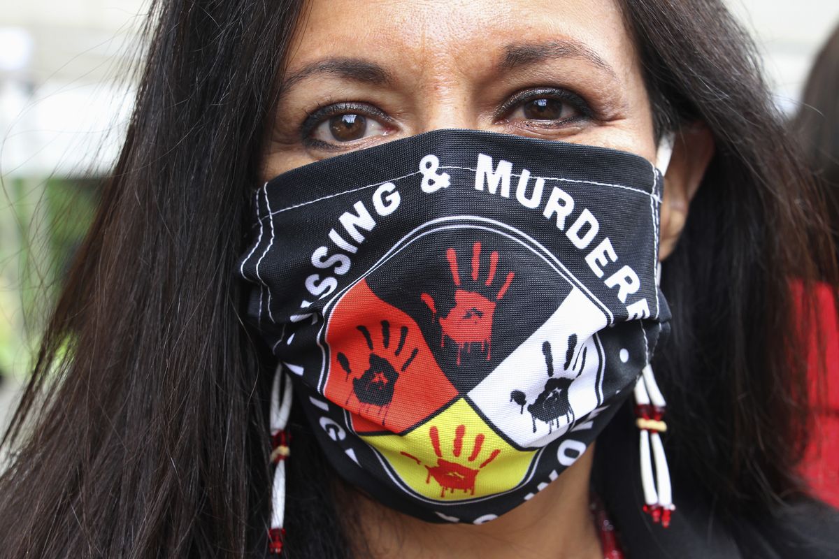 FILE - In this Wednesday, Aug. 26, 2020, file photo, Jeannie Hovland, the deputy assistant secretary for Native American Affairs for the U.S. Department of Health and Human Services, poses with a Missing and Murdered Indigenous Women mask, in Anchorage, Alaska, while attending the opening of a Lady Justice Task Force cold case office in Anchorage, which will investigate missing and murdered Indigenous women. From the nation’s capitol to Indigenous communities across the American Southwest, top government officials, family members and advocates are gathering Wednesday, May 5, 2021, as part of a call to action to address the ongoing problem of violence against Indigenous women and children.  (Mark Thiessen)