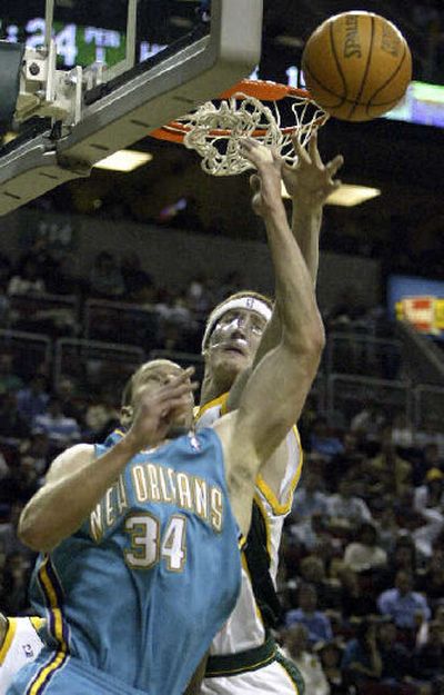 
Seattle's Robert Swift knocks a pass away from New Orleans' Aaron Williams during the first quarter of Tuesday's game in Seattle. 
 (Associated Press / The Spokesman-Review)