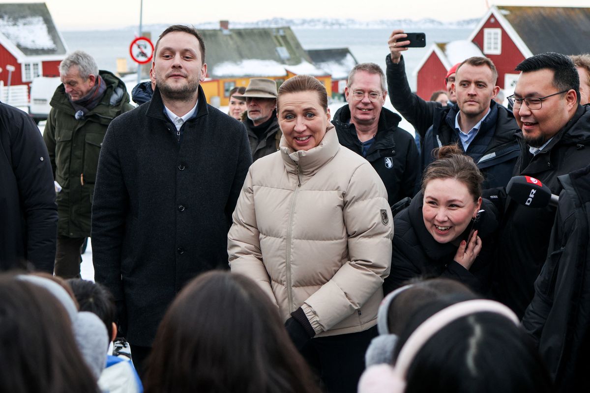 Greenlandic Prime Minster Jens-Frederik Neilsen, left, and Danish Prime Minister Metter Frederiksen greet people Friday in Nuuk, Greenland.  (Reuters)