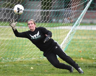 Kari Bromley, goalie of the East Valley Knights soccer team, deflects shots during practice Monday, Oct. 17, 2016, at East Valley High School. (Jesse Tinsley / The Spokesman-Review)