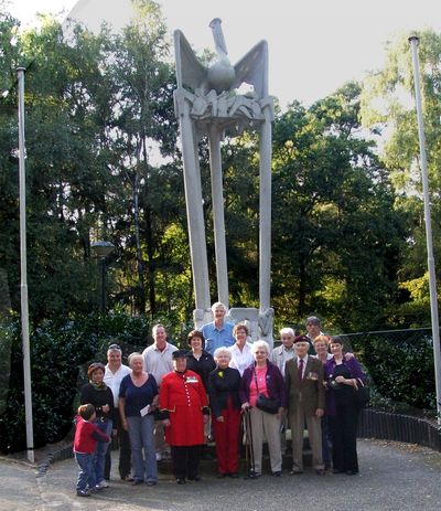 Members of the family of Army Pfc. Joe Mann  and two Spokane residents pose for a photograph at a monument erected in 1956 in Mann’s honor in  Best, Netherlands. At center in front is Irene Mann Bennett, of Ritzville, Wash., a sister of Joe Mann, and Mary Mann, of Redmond, Wash., a sister in-law. At far right  are Sue Walker and Rae Anna Victor, of Spokane. In back row are Byrne Bennett, a nephew, and his wife, Denise, of Medical Lake, and Rena Bennett Brown, of Ritzville, a niece. The others are residents of Best. The pelican is symbolic of self sacrifice.Courtesy photo (Courtesy photo / The Spokesman-Review)