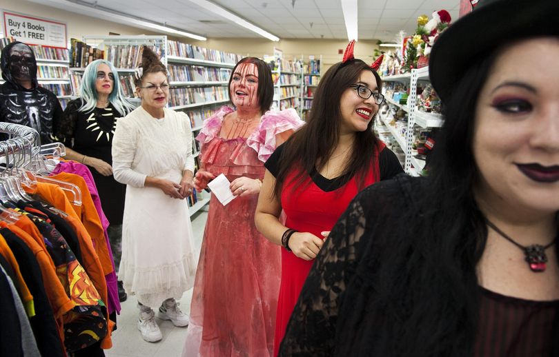 Employees at Value Village on West Boone Avenue line up for the store's traditional Halloween Costume Catwalk fashion show Thursday, Oct. 29, 2015, in Spokane. From left are Dan Uller, as the Grim Reaper. Priscilla Uberst, as a zombie, Aline Smith, as the Bride of Frankenstein, Britney Morgan, as the title character from the horror movie “Carrie”, Reu Jarvie, as the devil and Lindsey Green as a Goth. This was the season’s fourth and final catwalk, which has been held the past 10 years. (Dan Pelle / The Spokesman-Review)