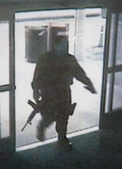 This surveillance camera frame grab shows a heavily armed man entering Santa Monica College in Santa Monica, Calif., on Friday. (Associated Press)