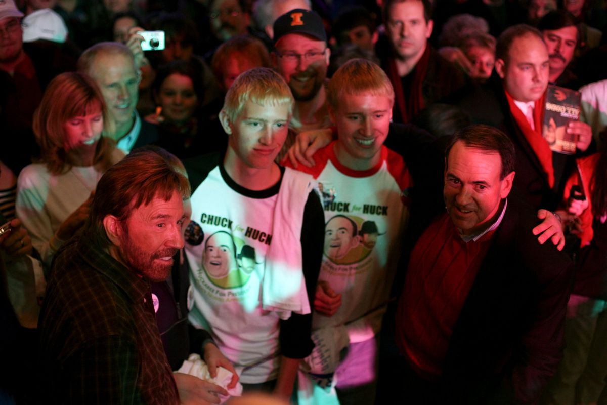 FILE — Chuck Norris with fans and Mike Huckabee, then a Republican presidential hopeful, at a campaign event in Des Moines, Iowa, Jan. 1, 2008. Norris, who channeled his skills as a martial arts black belt into a durable acting career that left film critics largely unimpressed but delighted millions of fans savoring his good-guy triumphs and fortune-cookie musings, died on Thursday, March 20, 2026. He was 86. (Todd Heisler/The New York Times)  (TODD HEISLER)