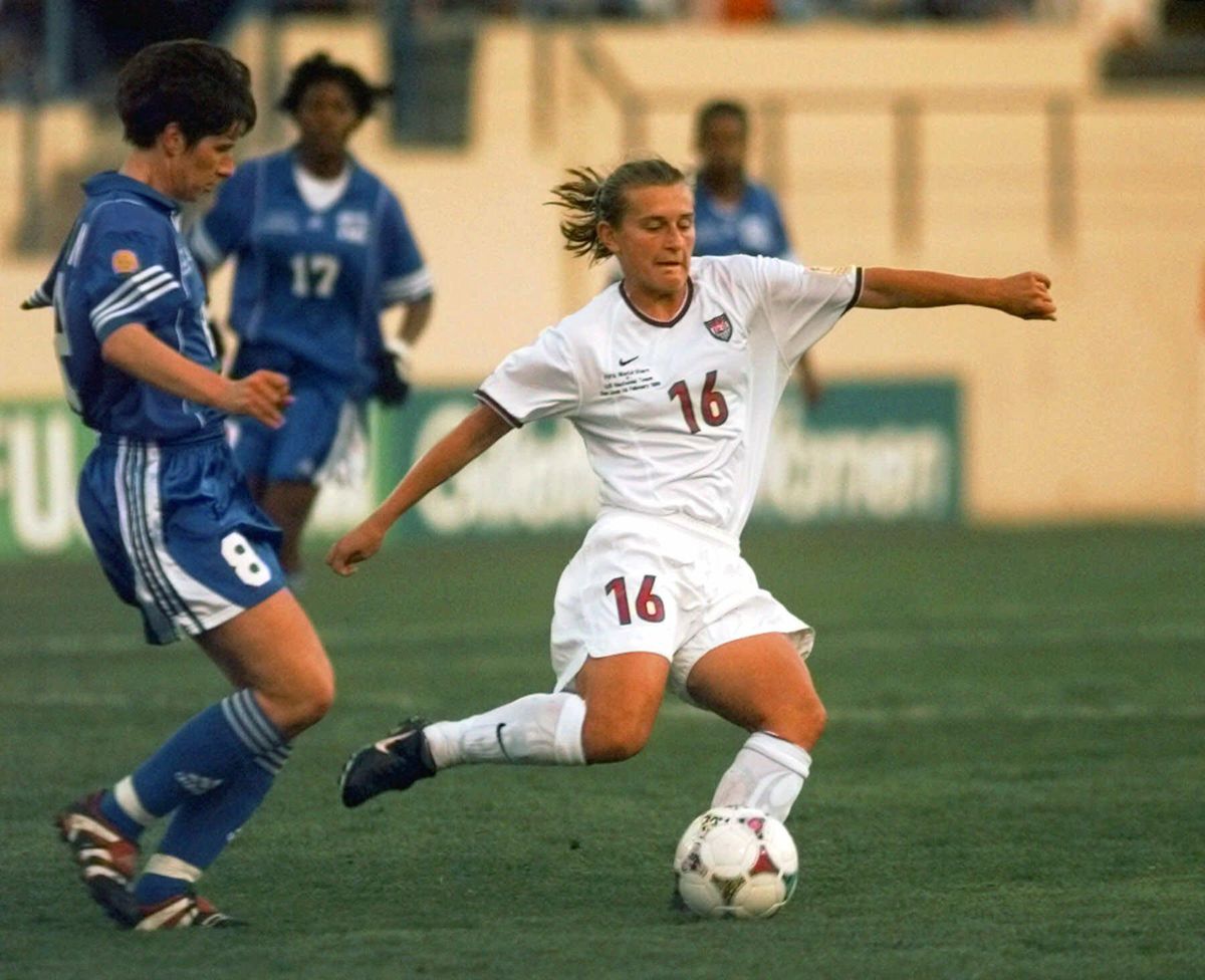 In this Feb. 14, 1999, file photo, U.S. national team forward Tiffeny Milbrett (16) advances the ball in the first half as world all-star defender Bettina Wiegmann (8) follows during an exhibition soccer match in San Jose, Calif. Millbrett will be inducted into the National Soccer Hall of Fame, announced Thursday, May 31, 2018. (Susan Ragan / Associated Press)