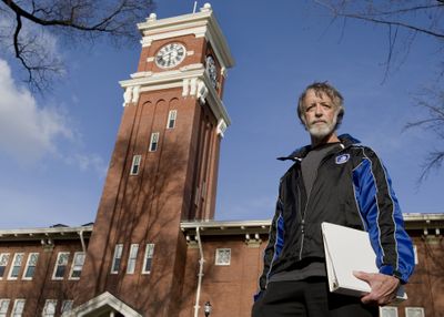 Rich Alldredge, a Washington State University professor of statistics and the president of WSU’s chapter of the American Association of University Professors, holds a folder of national and state AAUP bylaws Friday in front of Byron Clock Tower on the Pullman campus.Special to The Spokesman Review (TYLER TJOMSLAND Special to The Spokesman Review / The Spokesman-Review)