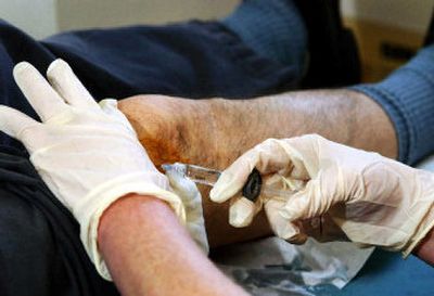 
Nurse practitioner Karen Nevico gives patient Rick Bolduc a shot of Synvisc in his knee at the Univeristy of Connecticut Orthopedic Associates office. 
 (Hartford Courant / The Spokesman-Review)