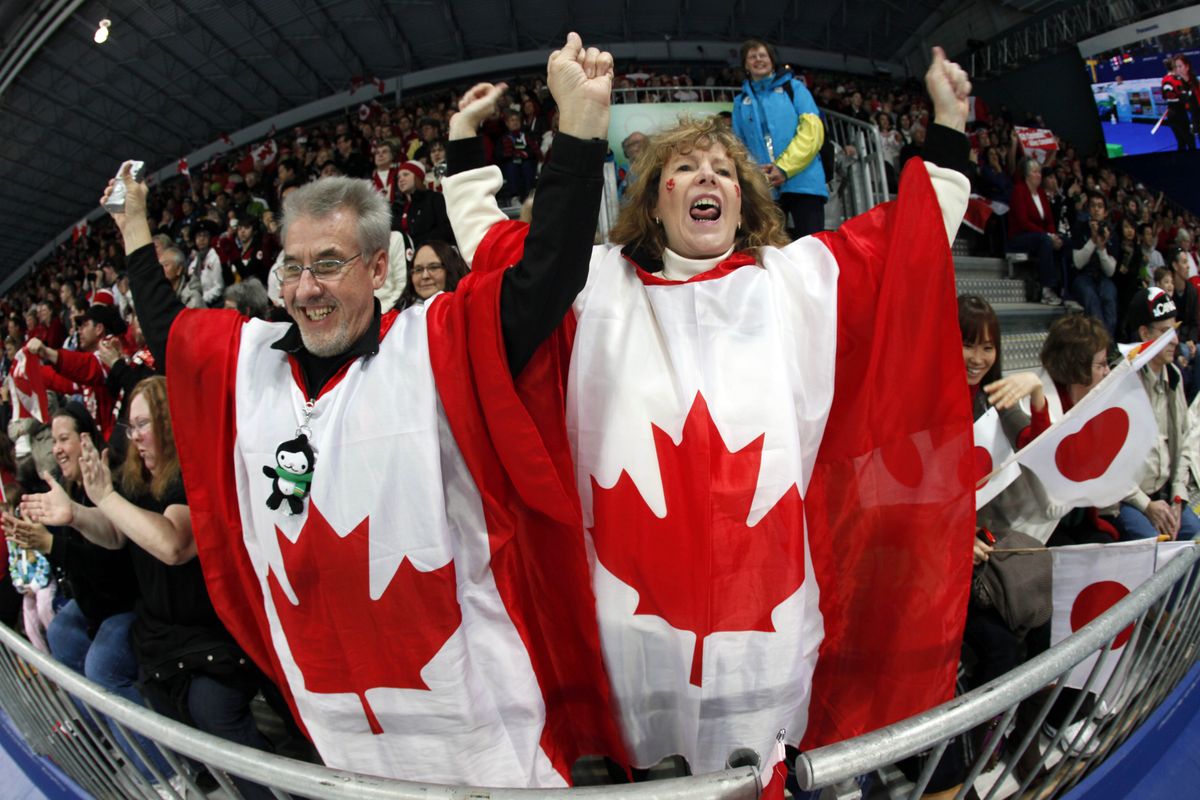 Chris Aldridge, of Winnepeg, and his sister, Shirley Aldridge, of Vancouver, show their national spirit as they cheer the Canadian women curlers Tuesday during their match against Switzerland. Associated Press photos (Associated Press photos)