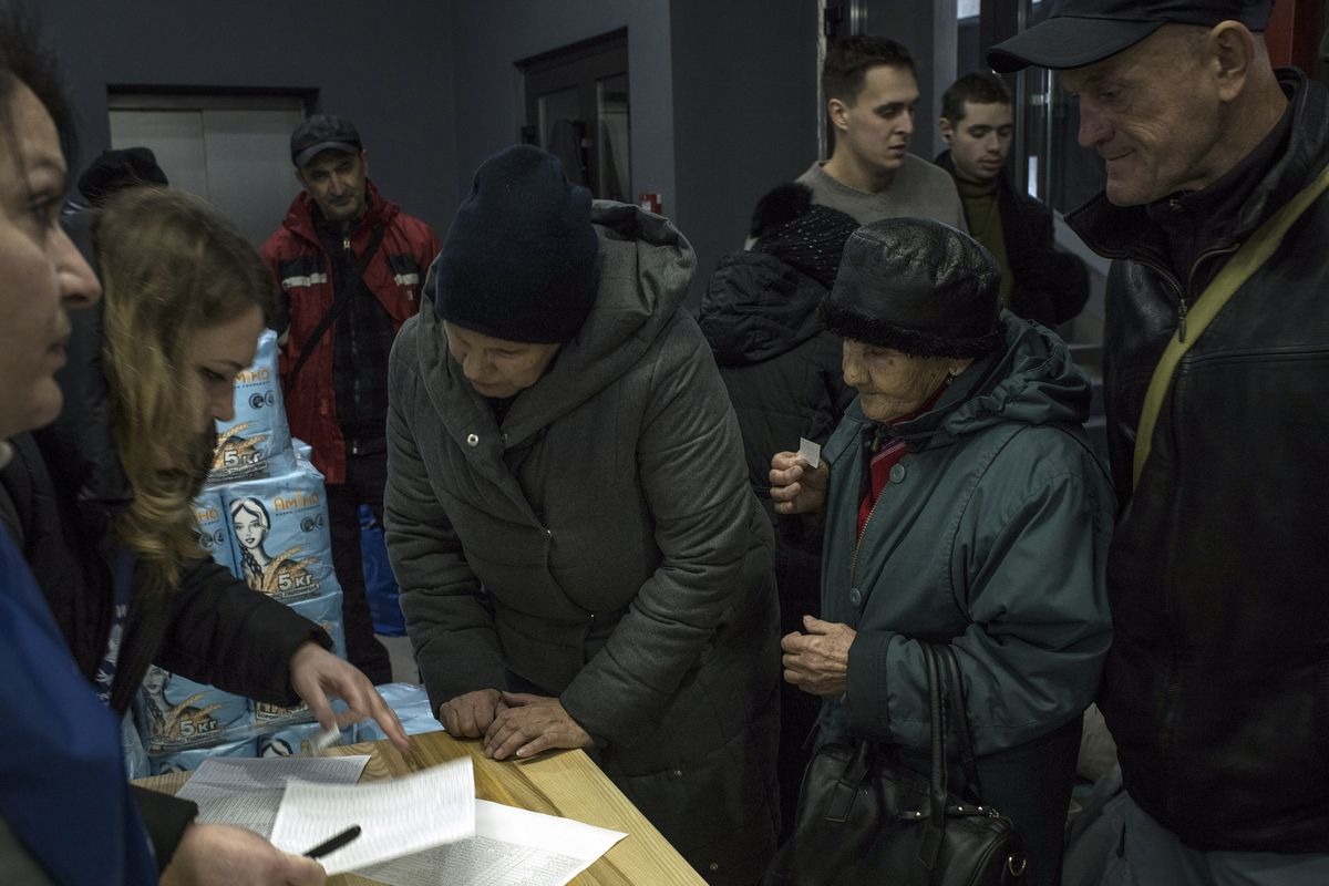 People register for aid in Kherson, Ukraine, on Friday, Dec. 9, 2022. Russian drone strikes on the southern Ukrainian port city of Odesa plunged more than 1.5 million people in the region into darkness on over the weekend, while 220 miles to the east, the Ukrainians struck the Russian-occupied city of Melitopol, an attack that opened another front in the fiercely contested battle for territory. (Laura Boushnak/The New York Times)  (LAURA BOUSHNAK)