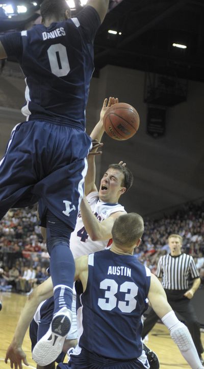 Three BYU players coverge on Kevin Pangos of Gonzaga who is fouled late in the game at the WCC  Tournament Saturday in Las Vegas.  (Christopher Anderson)