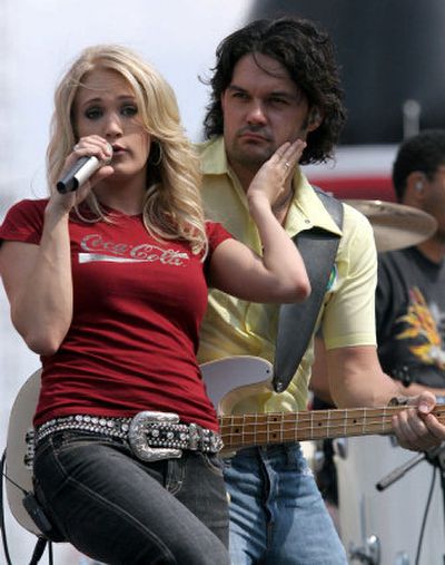 
Singer Carrie Underwood, left, performs before the NASCAR Nextel Cup Series Coca-Cola 600 auto race at Lowe's Motor Speedway in Concord, N.C.
 (Associated Press / The Spokesman-Review)