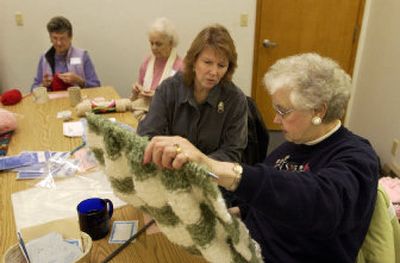 
Hospice of Spokane chaplin Maggie Albo, center right, talks with Alma Belisle about the progress she is making on  her prayer shawl at St. Mary's Catholic Church. The group, including Bobbie Bailey, far left, and Naomi Robinson, has been meeting every Monday since the fall. 
 (J. BART RAYNIAK photos / The Spokesman-Review)