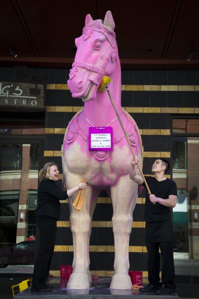 All in a day’s work: P.F. Chang’s employees Michelle Sampson and David Crane spent Monday afternoon scrubbing pink paint off the restaurant’s replica of a Chinese Qin Dynasty horse, which was painted in support of Sunday’s Susan G Komen Race for the Cure event. The paint went on easy, but the cleanup took some effort and elbow grease. (Colin Mulvany)