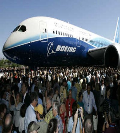 
Crowds examine the Boeing Dreamliner prototype at Boeing's Everett production facility. Despite delays, Boeing is not backing off its promise to deliver its first service-ready 787 to Japan's ANA late next fall. Associated Press
 (Associated Press / The Spokesman-Review)
