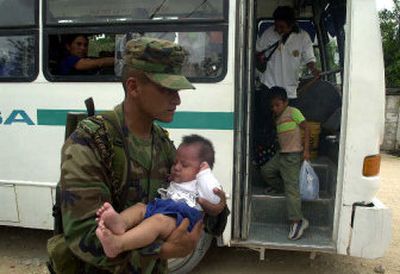 
A Mexican army soldier carries a baby into a shelter in Playa del Carmen, Mexico, on Sunday.
 (Associated Press / The Spokesman-Review)